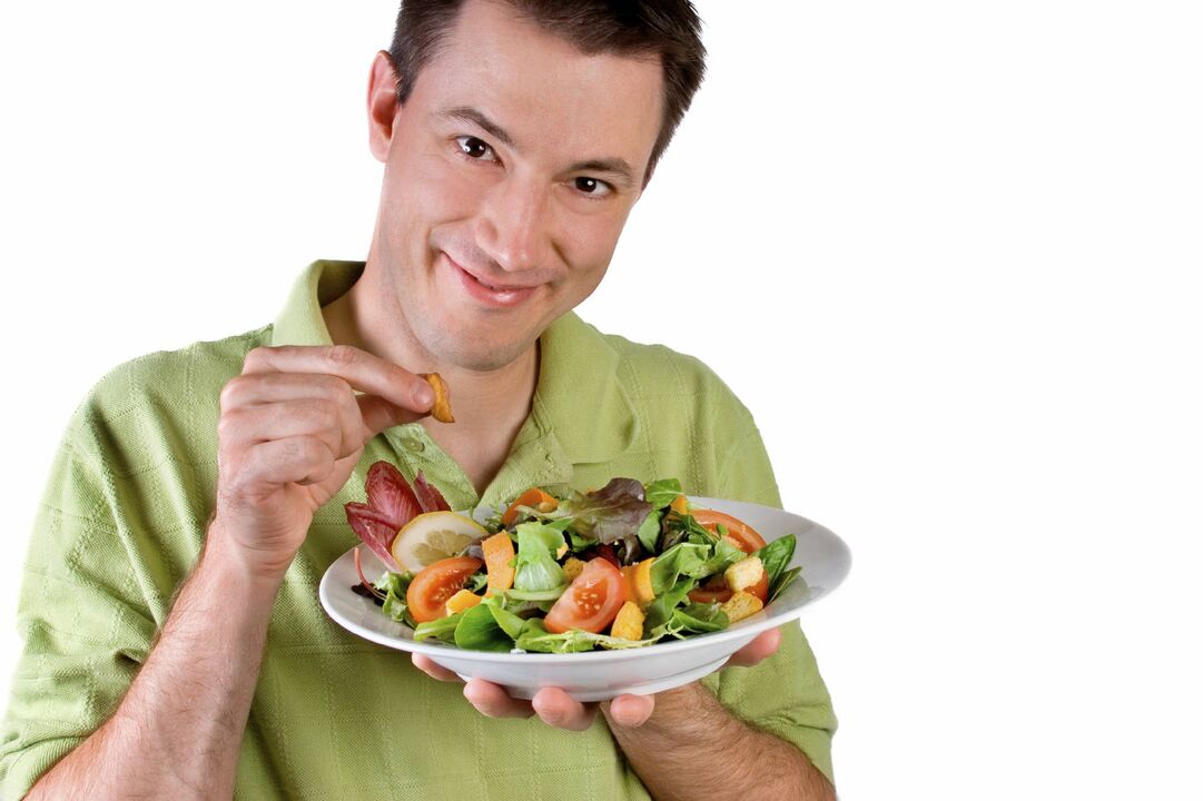 man eats vegetable salad for the sake of effect